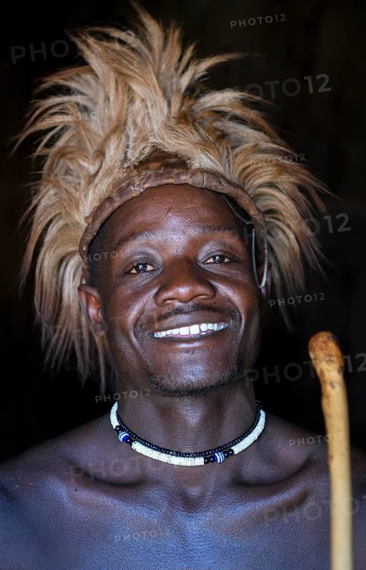 Young Himba man in his hut, Ohandungu, Kunene region, Kaokoveld, Namibia