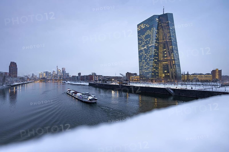 Snow lies along the banks of the Main from the European Central Bank (ECB) to the Frankfurt banking skyline, Osthafen, Frankfurt am Main, Hesse, Germany