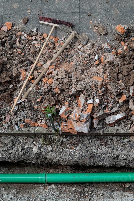 Newly laid green sewage pipe, trench, excavation, broom and pickaxe, Stuttgart, Baden-Württemberg