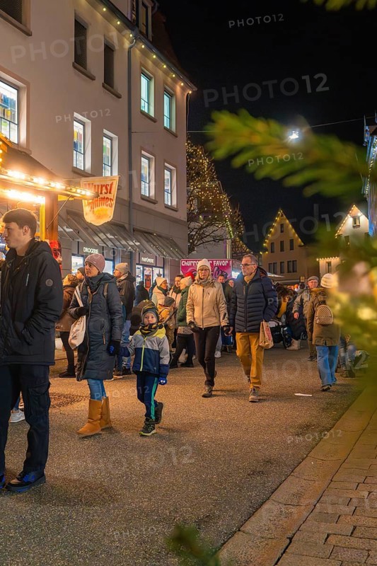 Visitors stroll through the illuminated Christmas market, enjoy the wintry atmosphere and festive lights, Night of Lights, Nagold, Black Forest, Germany
