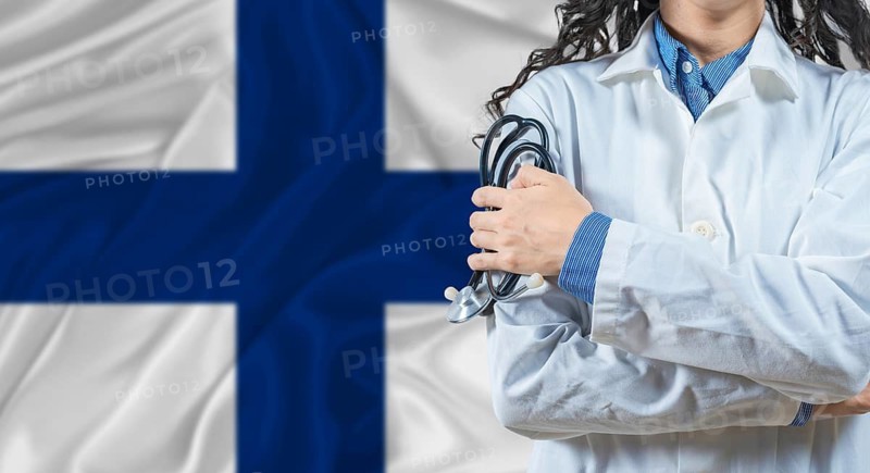 Healthcare professional with Finland flag background. Professional doctor holding stethoscope on Finland flag background