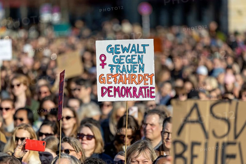 Berlin, Germany - 22.3.2026: Demonstrators, including one holding up a poster with the inscription: - Violence against woman endangers democracy - protesting in front of the Brandenburg Gate under the theme Demonstration against sexualized digital violence - Solidarity with all victims and in solidarity with Collien Fernandes. A few days ago, Collien Fernandes had publicly accused her ex-man Christian Ulmen of creating and disseminating fake profiles of her pornographic content with deepfake