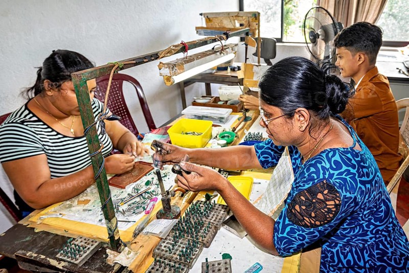 Craftsmen work on making jewelry in a workshop, concentrated and in groups, The sapphire and gemstone cutters near Ratnapura in Sri Lanka