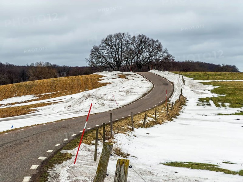 Winter, soon spring. Snowmelt. country road in landscape with melting snow in Ystad municipality, Skåne county, Sweden, Scandinavia