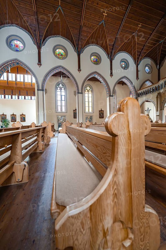 Interior view of a church with wooden benches and stained glass windows, Bad Wildbad, St.Bonifatius, Catholic parish, Black Forest, Germany