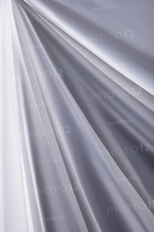 White transparent silk cloth waves background texture close-up