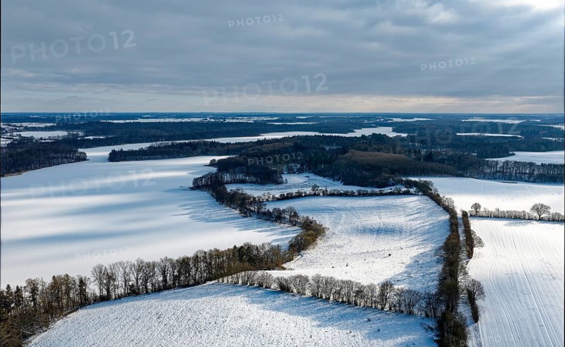 There is snow on the fields and lakes in the UNESCO Schaalsee Biosphere Reserve. aerial view. Dutzow, Mecklenburg-Western Pomerania, Germany