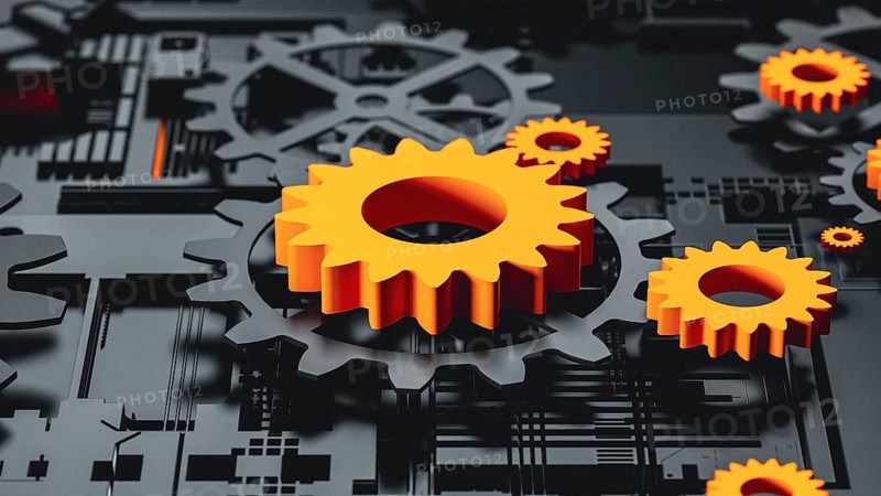 This abstract 3D background features a complex arrangement of gears in black and orange. The texture and pattern create a dynamic visual effect