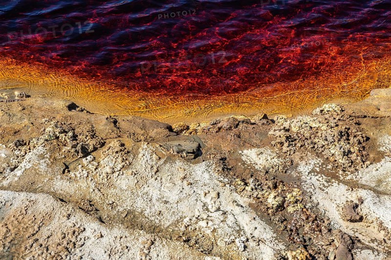 Vivid colors define the Riotinto River in Huelva, Spain Its striking red waters and rugged, mineral-rich shoreline create a unique and captivating natural landscape