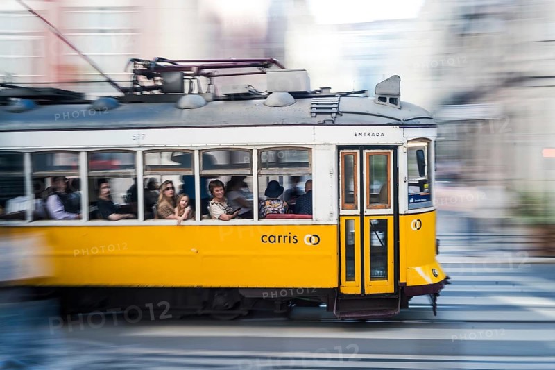 LISBON, PORTUGAL - MAY 20, 2025: Famous tram at the street of the city. Photo taken using the panning technique