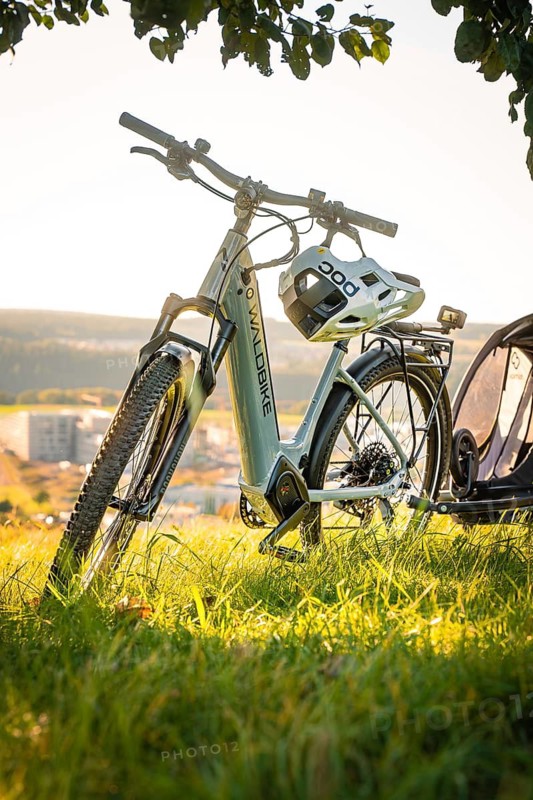 E-bike with helmet and trailer standing in the grass with a wide view in the background, e-bike, forest bike, Calw, district of Calw, Black Forest, Germany