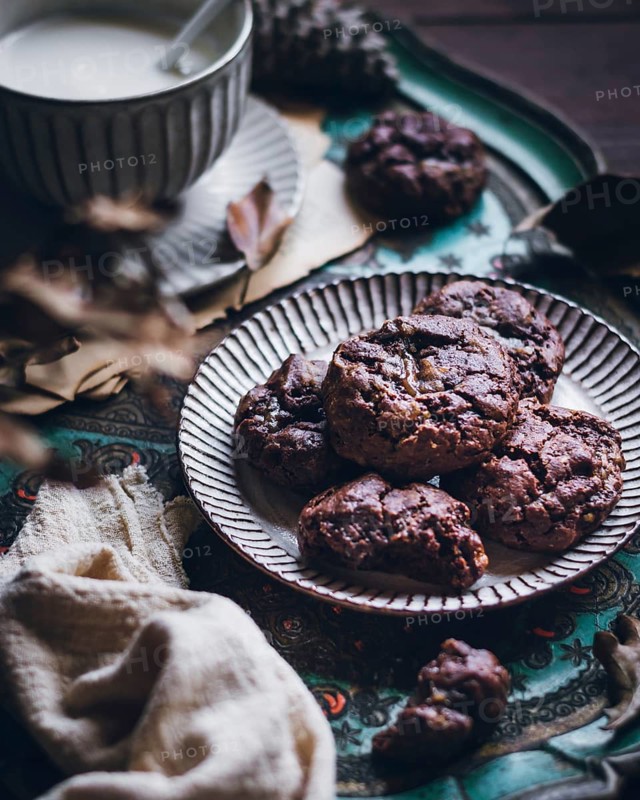 Rustic setting showcasing freshly baked chestnut cookies arranged on an ornate plate. A warm, inviting atmosphere perfect for cozy moments, highlighting the rich texture of the cookies