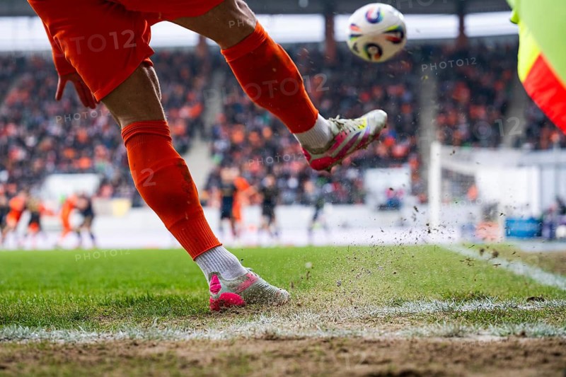 Footballer takes the corner. Detail of player's legs and the ball during soccer match in Lubin, Poland