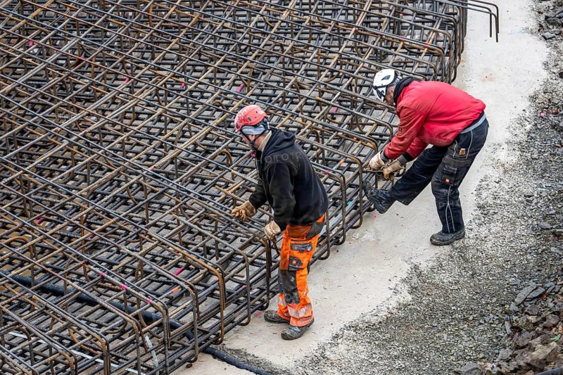 Assembly of reinforcing steel for the reinforced concrete foundation of a wind turbine, a mesh of rebar and reinforcing steel mesh, connecting the steel elements with binding wire, twisting with tongs, over 100 tons of reinforcing steel were used, the wind turbine will have a hub height of 160 meters, part of a new wind farm in Sauerland, near Balve, North Rhine-Westphalia, Germany