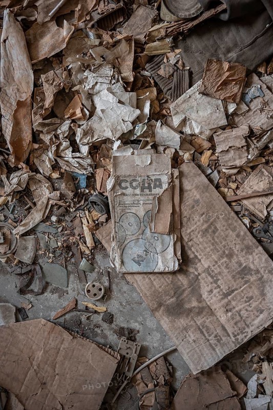 Rubbish and old instructions in Cyrillic script, abandoned destroyed room in a residential building, Soviet apartment blocks, ghost town, Engilchek, Tian Shan, Kyrgyzstan