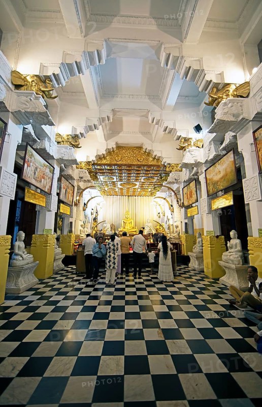 Sri Lankan pilgrims at the golden Buddha in the Buddhist Temple of the Tooth or Sri Dalada Maligawa, Kandy, Central Province, Sri Lanka