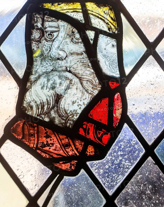 Stained glass window depiction of medieval man face, Bristol cathedral church, Bristol, England, UK