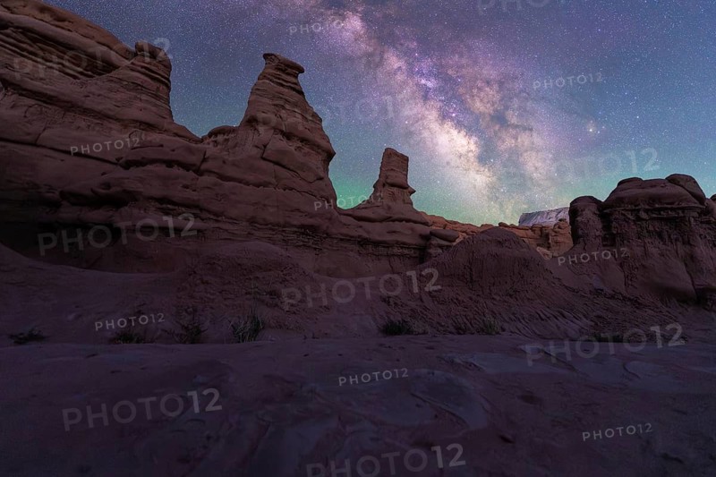 A breathtaking night scene at Goblin Valley State Park, Utah, showcasing stunning sandstone formations under a star-filled sky and the vivid Milky Way in a mesmerizing display