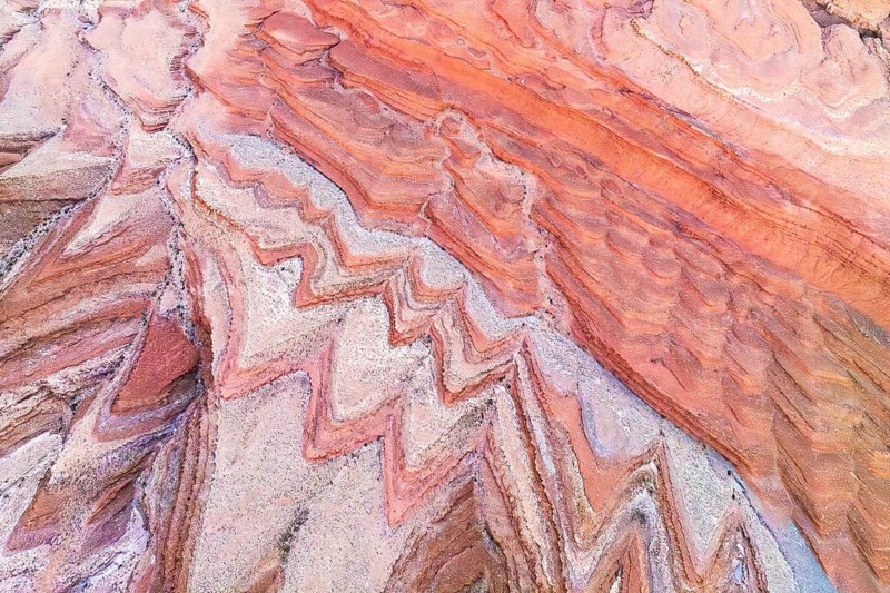 A stunning aerial photograph capturing the intricate, colorful rock formations near the San Juan River in Utah, showcasing nature's artistry in the canyon landscape