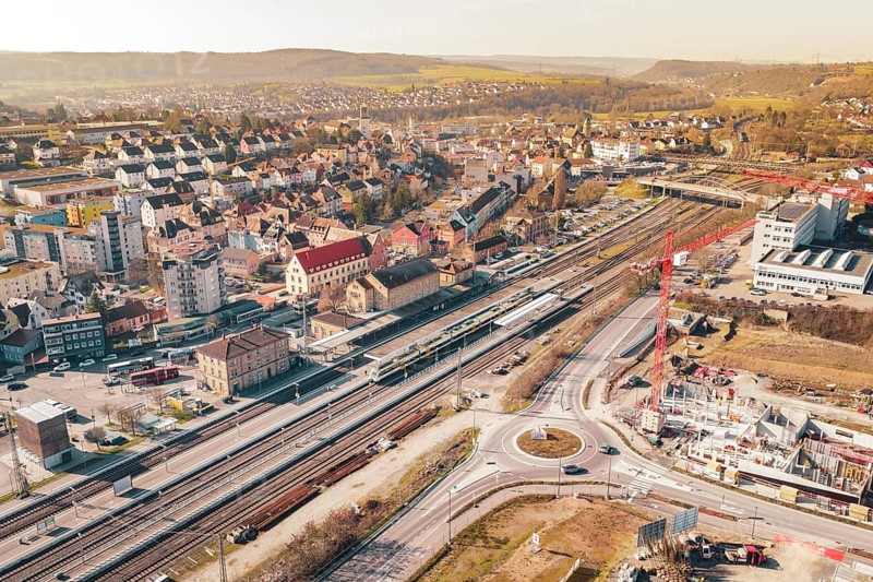 Urban development with construction cranes and railroad tracks, surrounded by residential buildings, Mühlacker, Enzkreis, Germany