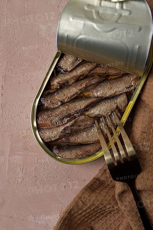 Sprats in oil, canned smoked fish, open, close-up, top view, no people