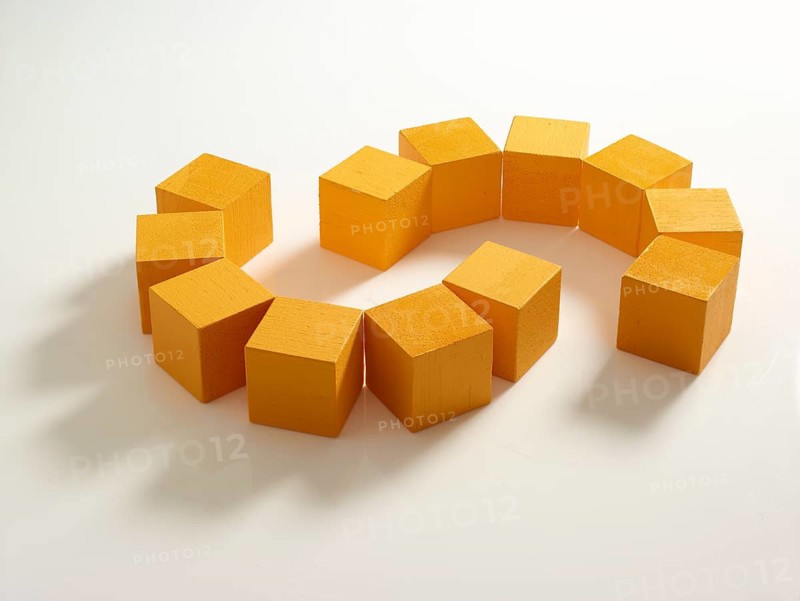 12 yellow wooden cubes against a white background