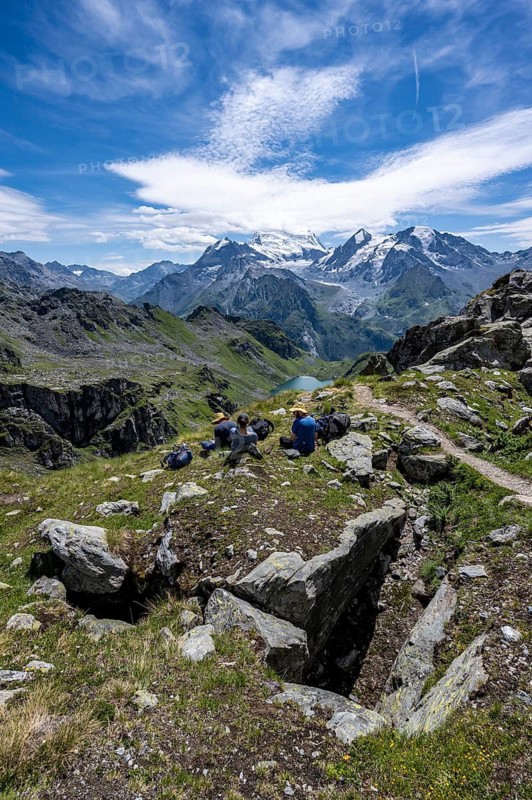 Mountaineers resting in a mountain landscape, descent at Col du Louvie, view of the summit of the Grand Combine, Valais Alps, Val de Bagnes, Valais, Switzerland