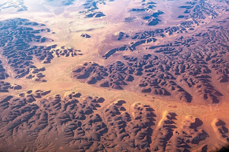 Aerial view of extensive sand dunes and geomorphological forms in a desert environment, The dunes of the Endless Sahara from the air in Algeria