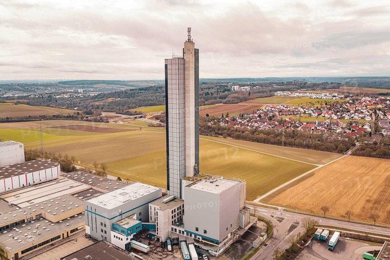 Industrial complex with tower surrounded by fields and villages under a cloudy sky, Schapfenmühle, Jungingen, Ulm, Germany