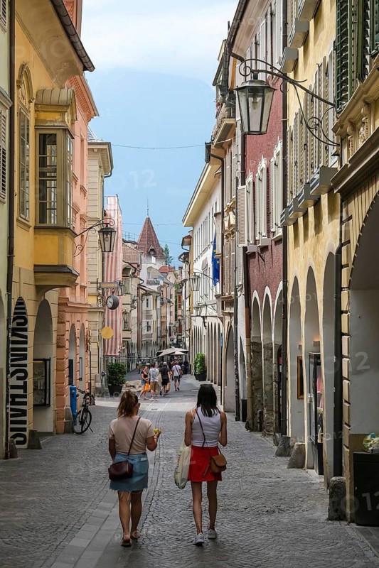Merano, South Tyrol, Italy, A few passers-by stroll through the Laubengasse, the arcades are the heart of the old town centre