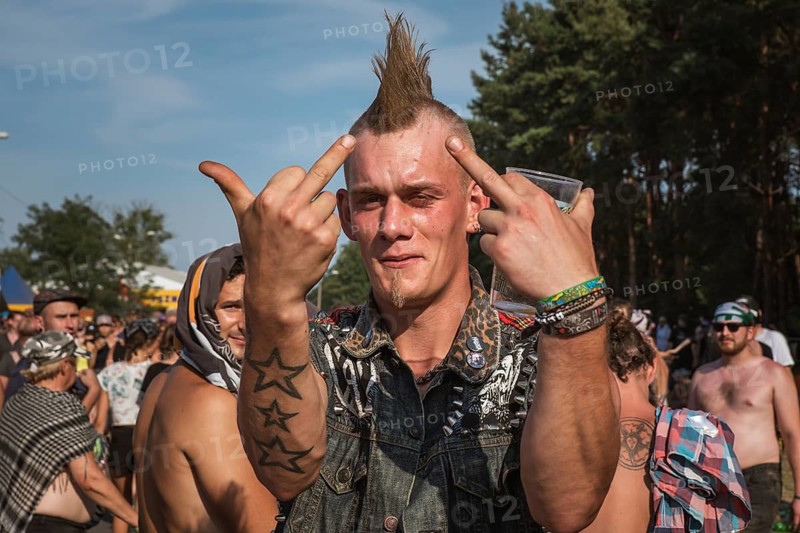 KOSTRZYN NAD ODRA, POLAND - AUGUST 2, 2018: Fan of the Pol'and'Rock Festival shows middle fingers