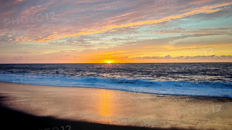 Sunset at sea shows a colorful spectacle in the sky and reflects on the water, hiking, Tarrafal de Monte Trigo, Santo Antao, Cabo Verde, Cape Verde, Cape Verde