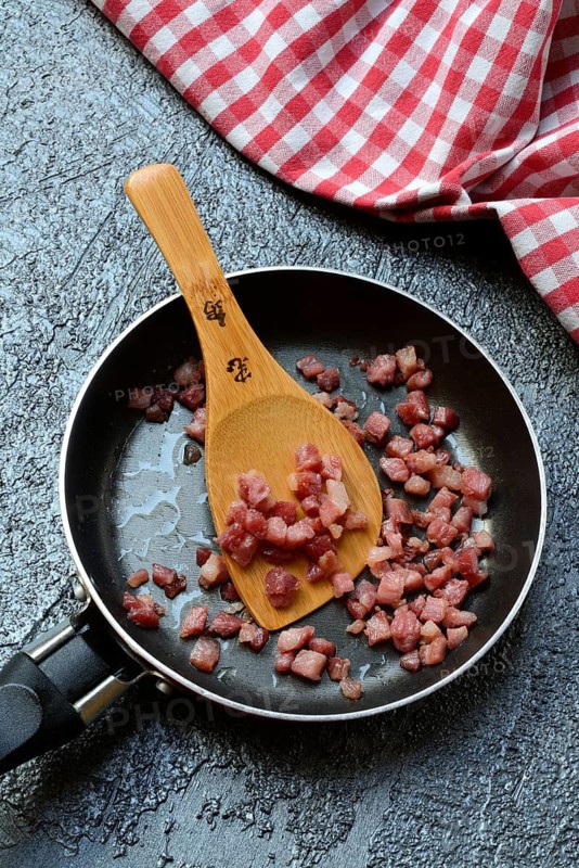 Fried bacon cubes in pan, bacon