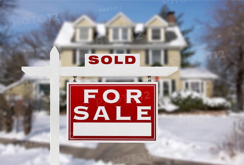 Sold Home For Sale Real Estate Sign in Front of New Snow Covered House