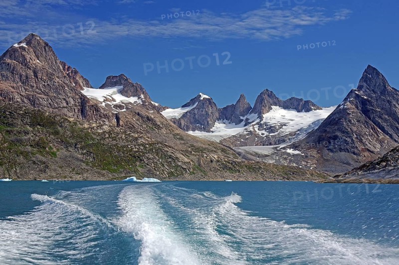 Bow wave a boat of snow-covered mountains in a clear fjord, Tasilaq, Arctic, Greenland, Denmark