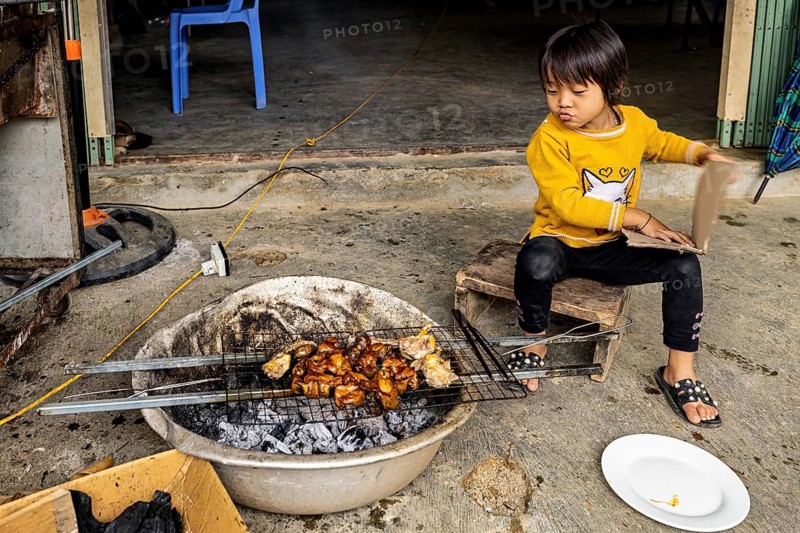 A boy grills meat on the street in the Sa Pa area of Vietnam