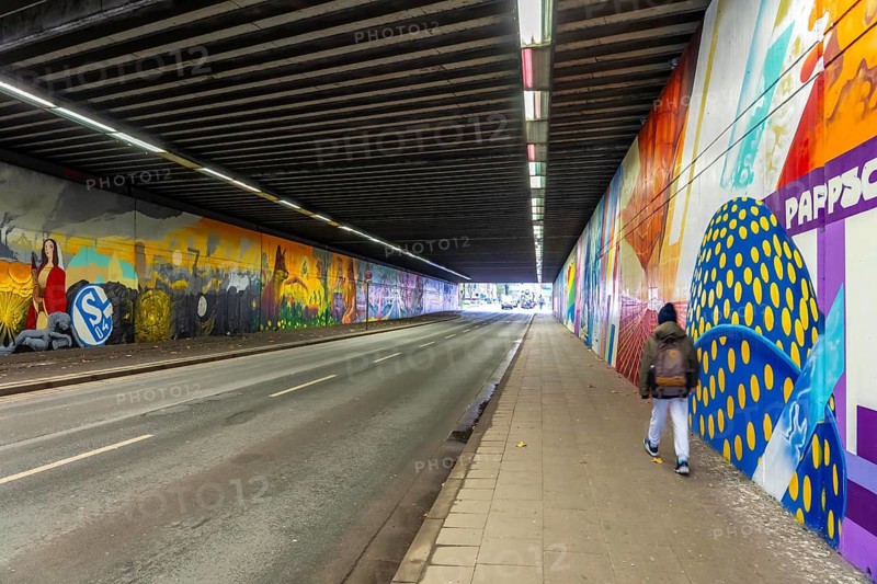 Huge street art pictures in a road tunnel in Gelsenkirchen, the approximately 120 meter long railway underpass of Wickingstraße was extensively painted and sprayed on both sides by 11 Gelsenkirchen graffiti artists and collectives, over a total length of 174 meters, the wall paintings showed motifs from Gelsenkirchen history, from economy, coal, steel, soccer, Schalke 04, culture, life, to the 150.year-old city Anniversary on 29.11.25, North Rhine-Westphalia, Germany