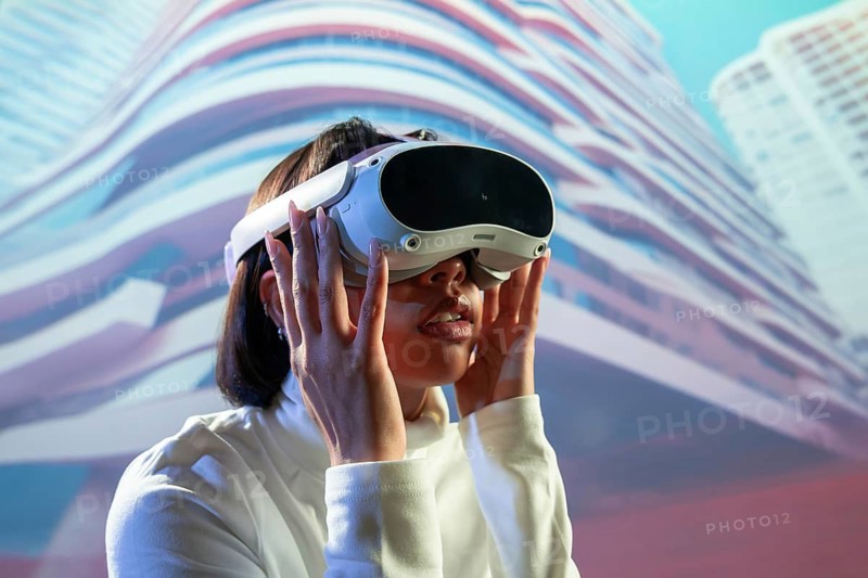 A Latin woman wearing virtual reality glasses is deeply immersed in a digital experience, exploring new realms with advanced technology in a modern, futuristic environment