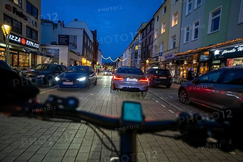 Cycling in the city, in the dark, in the evening, inner-city road, bicycle road, two-wheeler traffic has priority, 30 km/h zone, cyclist perspective, Essen, North Rhine-Westphalia, Germany