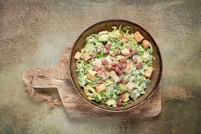 Brussels sprouts Caesar salad, with bacon and croutons, healthy food, homemade, no people