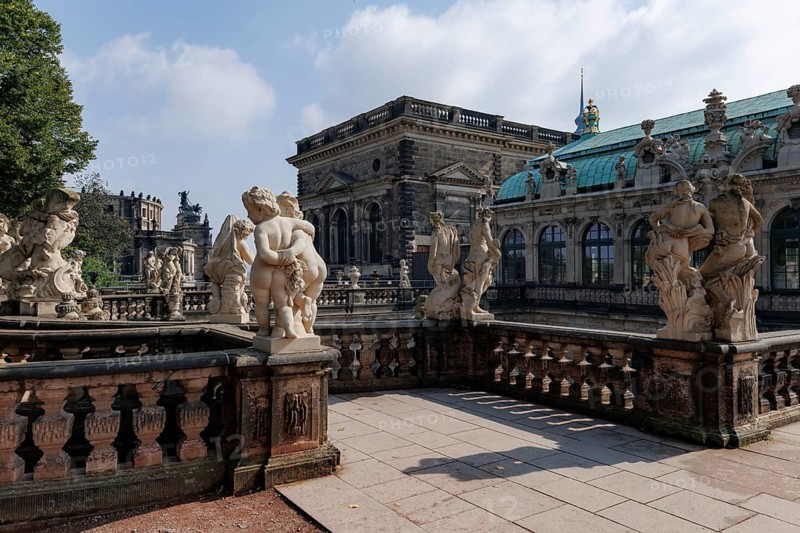 Stunning view of intricate sculptures at Zwinger Palace in Dresden, Germany. The Baroque architecture and detailed stonework highlight the historical elegance of this famous landmark