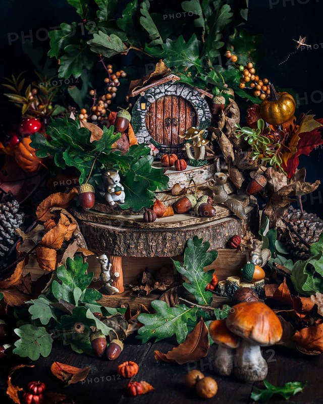 A whimsical miniature forest scene captures the essence of autumn with vibrant leaves, mushrooms, and a fairy tale setting. Acorns and twigs add charm to the woodland landscape