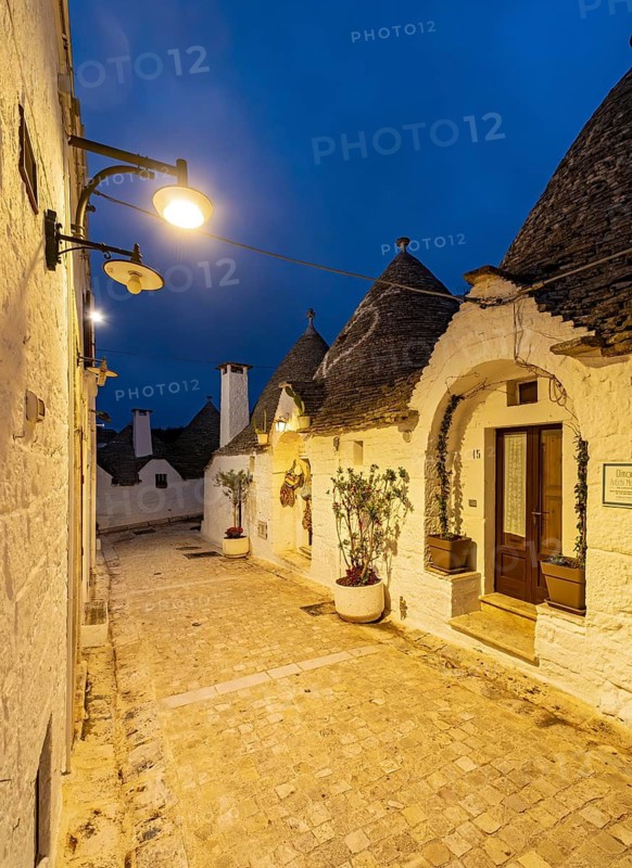 Street with Trulli houses by night, Rione Monti, Alberobello, Apulia - Puglia, Italy