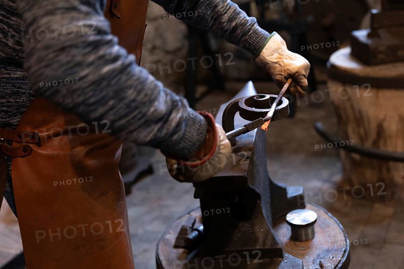 An elderly blacksmith in Salzburg preserves centuries-old blacksmithing traditions. His skilled hands craft unique metalwork, embracing a timeless craft