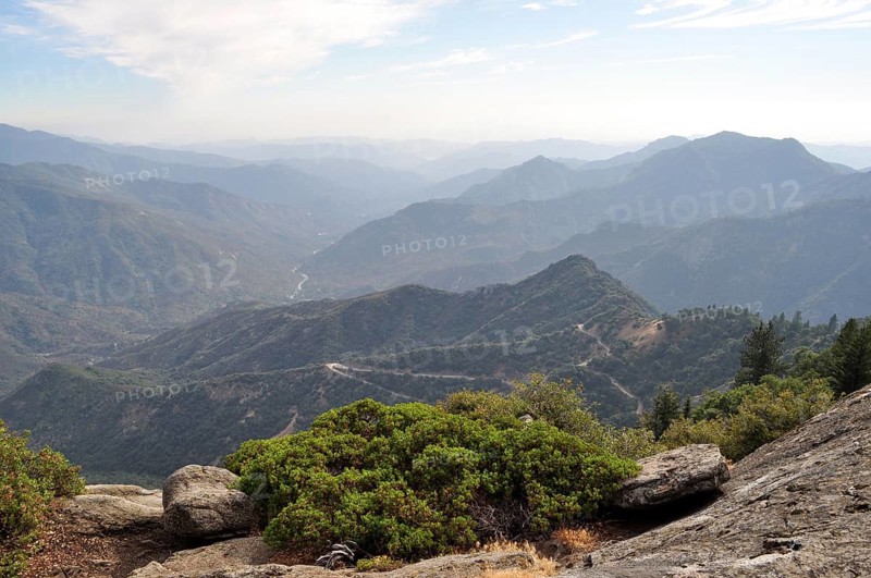 View of wooded valleys and distant mountain ranges under milky skies, Sequoia National Park, California, USA