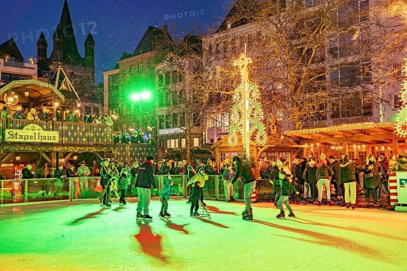 Christmas market Heinzel's winter fairy tale with the ice rink at Heumarkt at dusk, Cologne, North Rhine-Westphalia, Germany