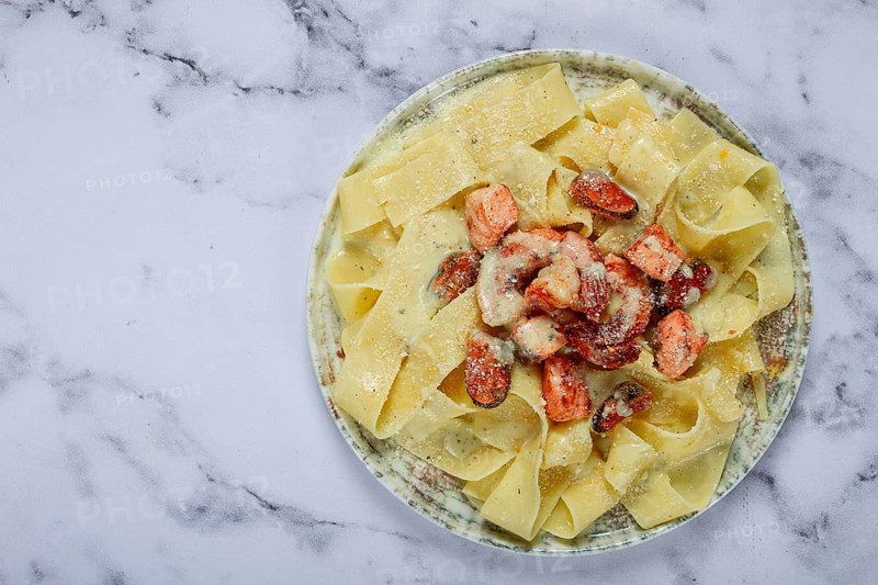 Papardelle pasta in creamy sauce with seafood, homemade, no people