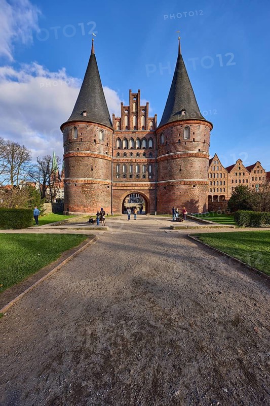 City gate, historic brick building, footpath made of sand, garden with lawn, Holstentorplatz, Hanseatic city of Lübeck, independent city, Schleswig-Holstein, Germany
