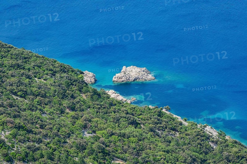 View from Lubenice across the sea with coastal landscape and bays on a sunny day on the island of Cres, Croatia