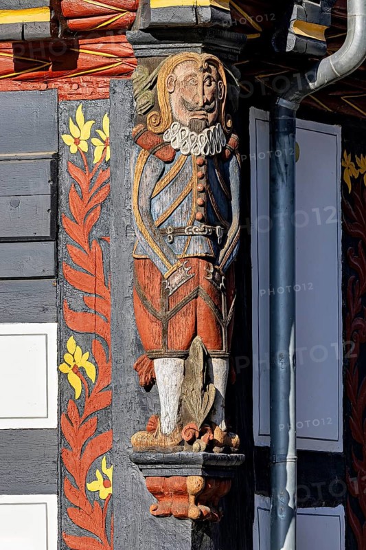 Decorated wooden figure on a half-timbered house, shows Renaissance elements with bright colours and floral patterns, wood carving and figure on a half-timbered house in Melsungen